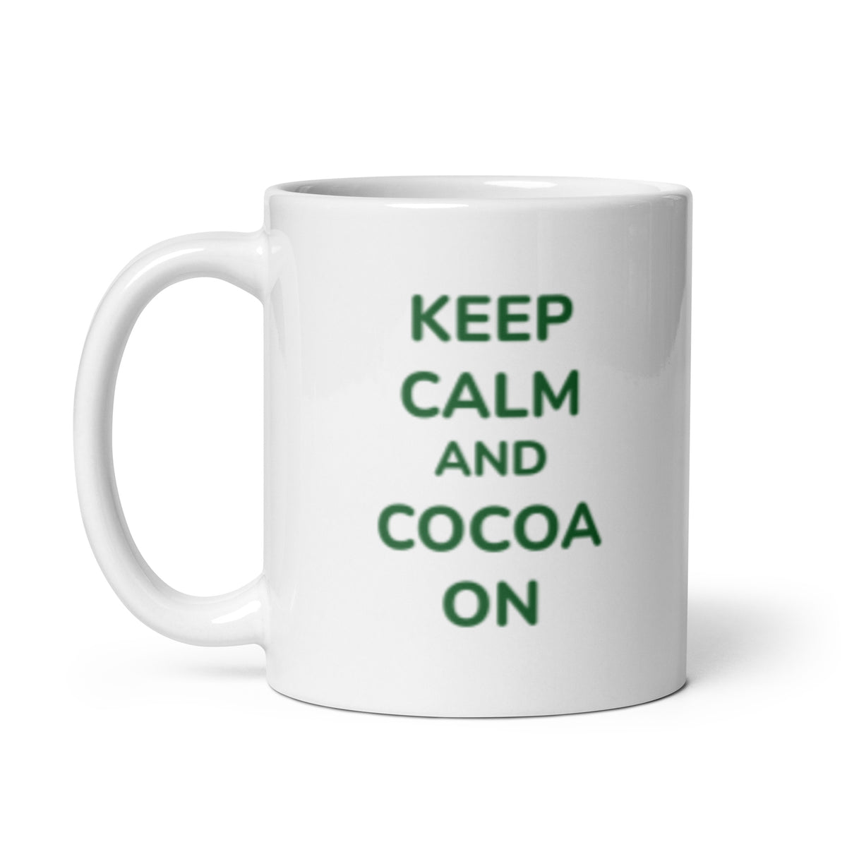 Image of a white ceramic mug with the phrase &#39;KEEP CALM AND COCOA ON&#39; printed in bold green letters. This mug is perfect for sipping on dairy-free, gluten-free, refined sugar-free, soy-free, plant-based, vegan, non-GMO, Paleo, organic, and kosher hot cocoa.